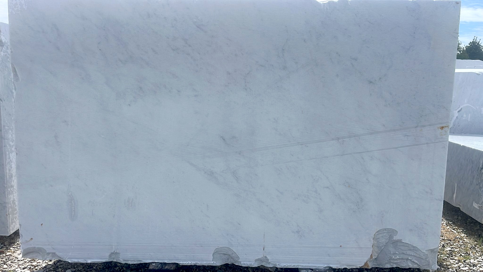 Bianco Carrara marble slab: cloudy white base with elegant grey veining — classic Italian marble from Carrara